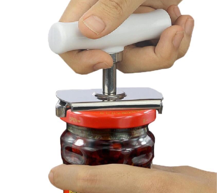 Person using a jar opener to open a jar with a white background