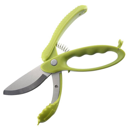 Serrated scissors slicing vegetables for a salad.