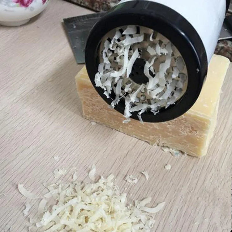 Ergonomic multi-function kitchen grater, grating aged parmesan.