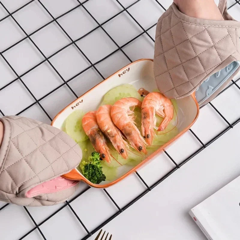 Glove in use, holding a hot tray safely.