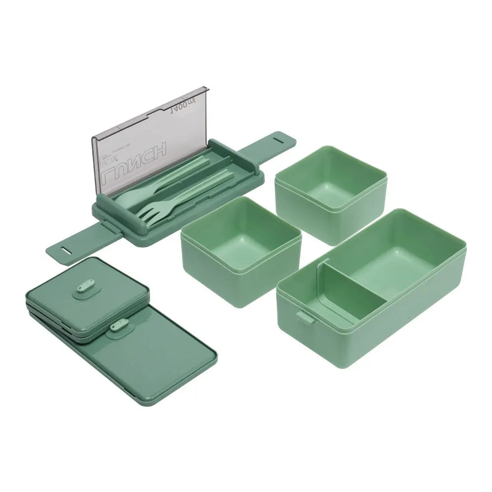 Green lunch box set with compartments and utensils on a white background