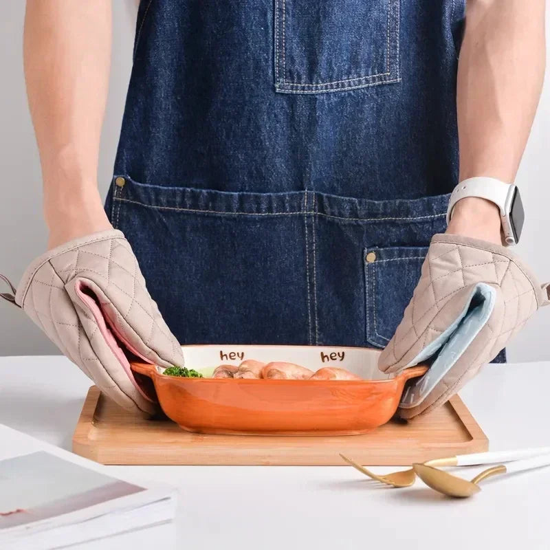 Glove in use, holding a hot tray safely.