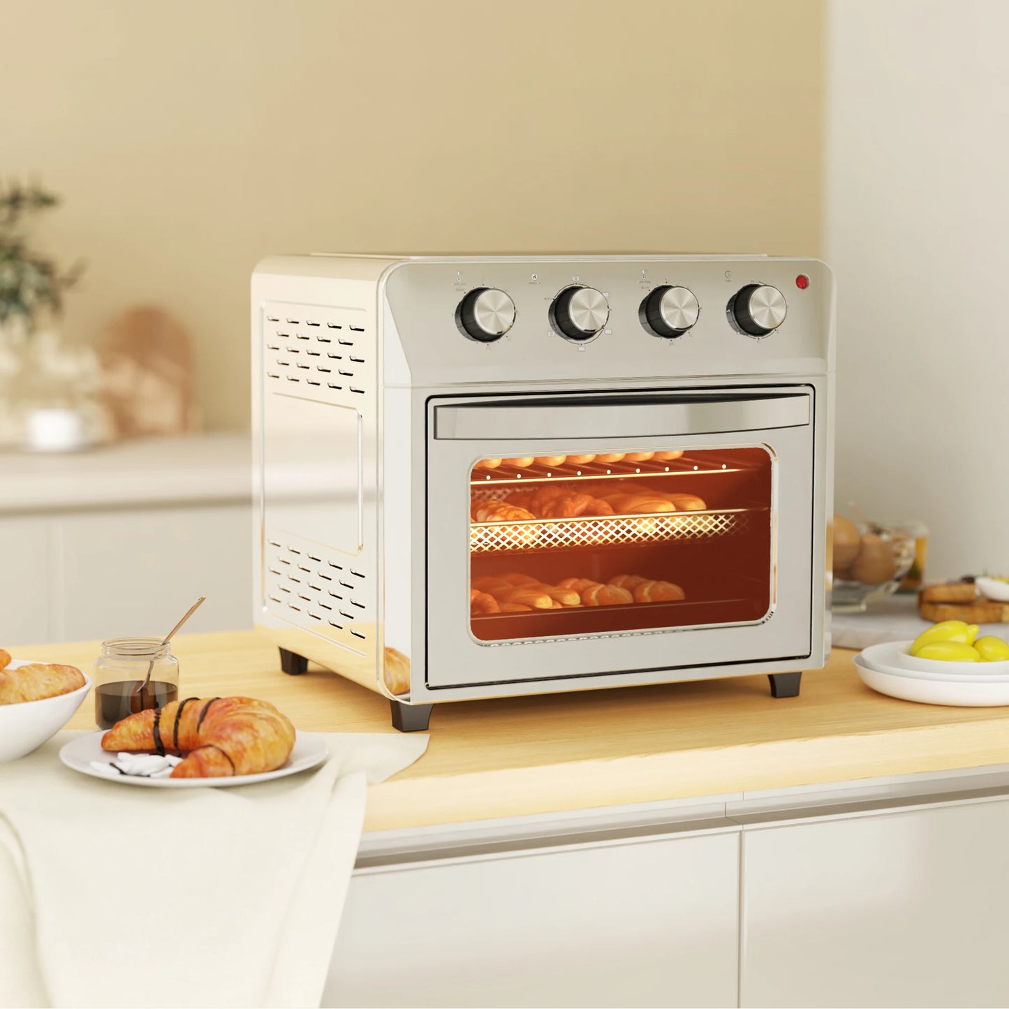 Small oven on a kitchen counter with food inside, surrounded by breakfast items.