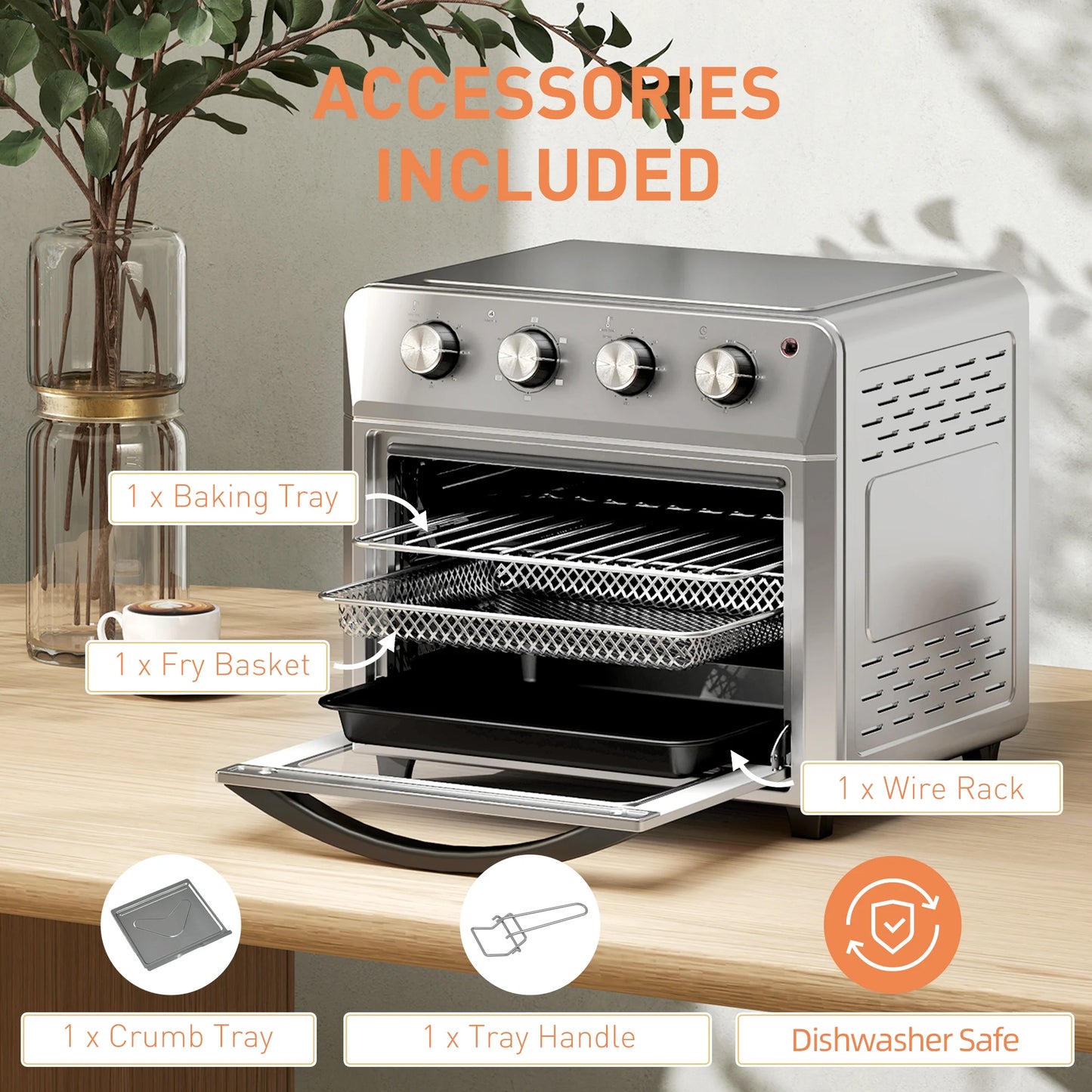 Silver toaster oven with accessories on a wooden surface, including a baking tray, fry basket, wire rack, crumb tray, and tray handle.