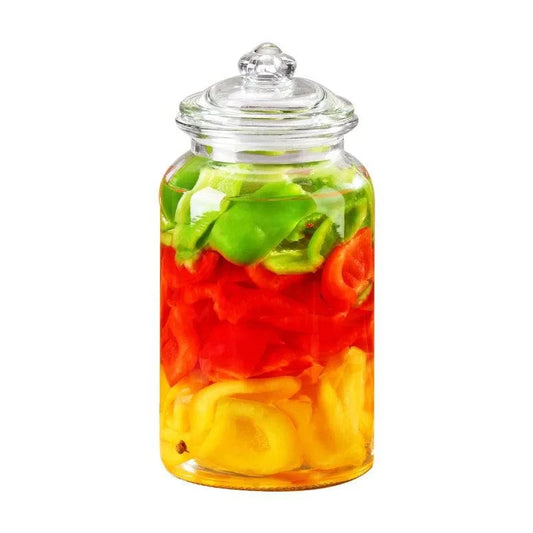 Clear glass candy jar on kitchen counter storing honey and nuts