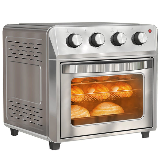 Stainless steel toaster oven with bread baking inside on a white background
