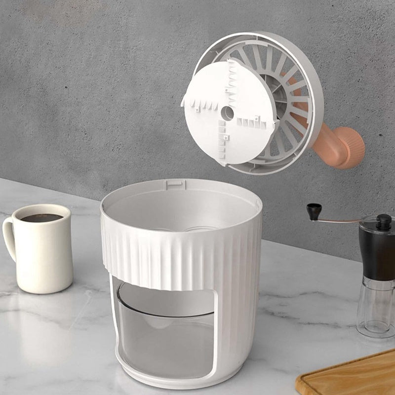 White coffee grinder with a clear container on a marble surface, with a cup of coffee and a coffee grinder in the background.