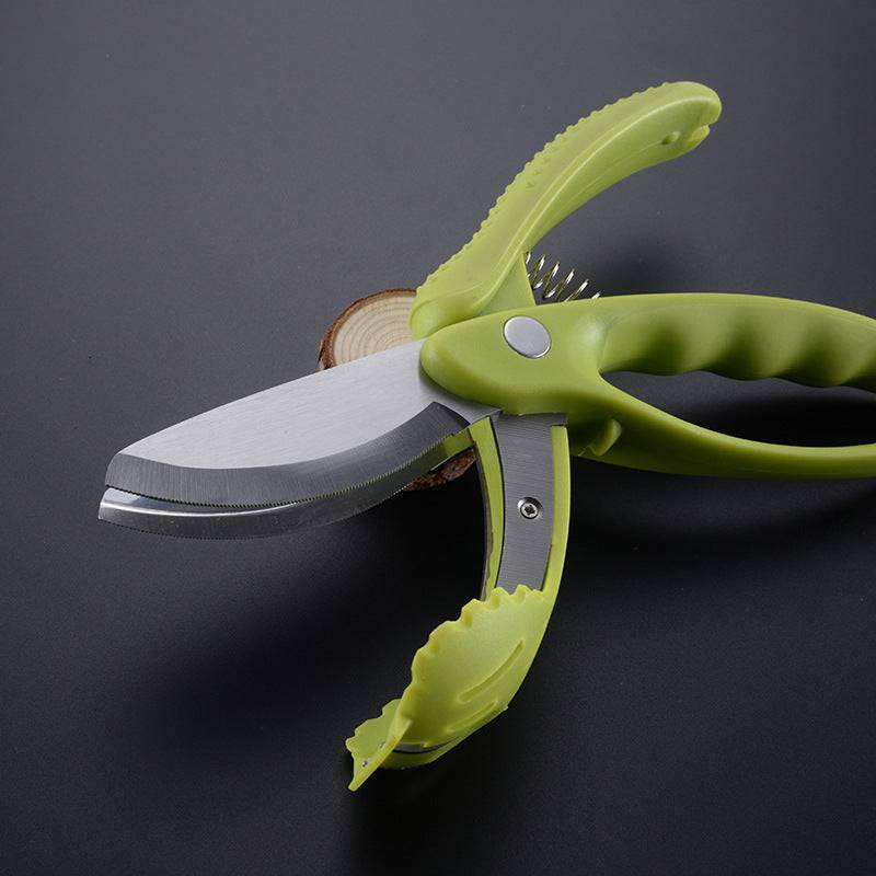 Preparing fresh salad with serrated vegetable scissors.