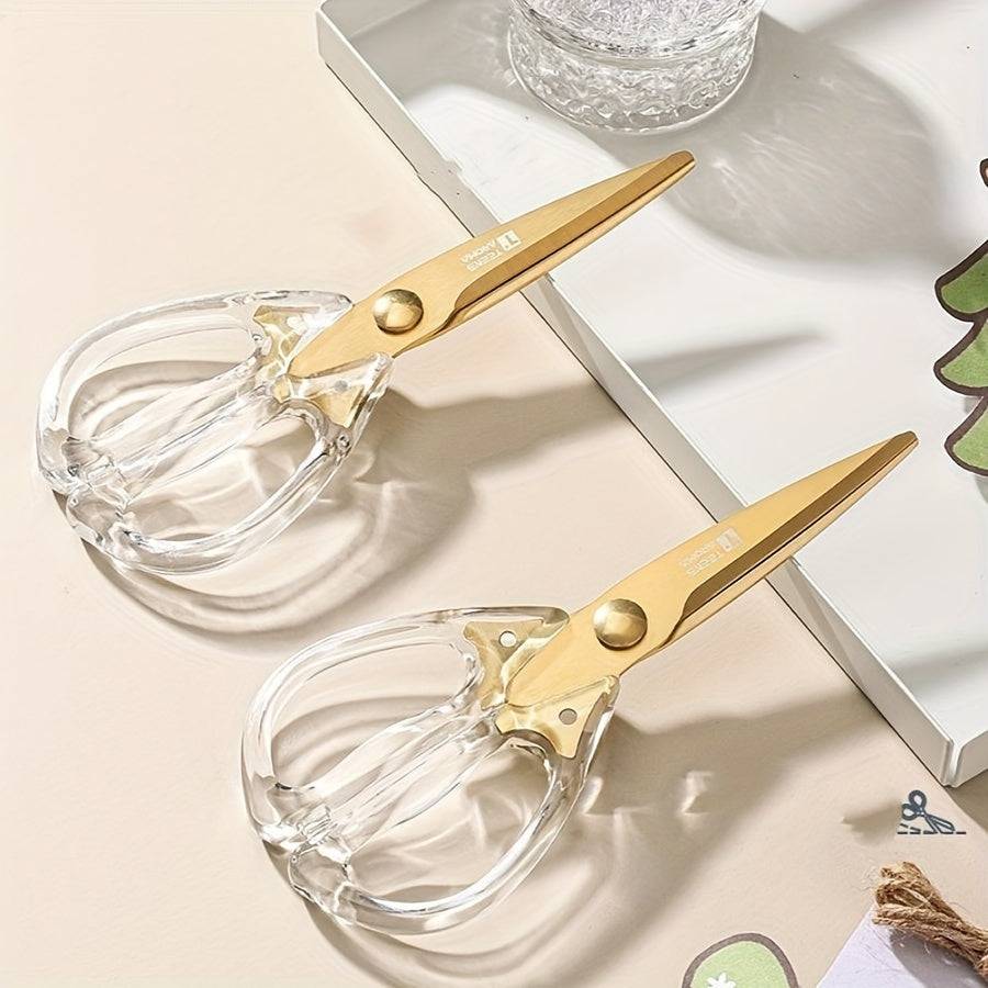 Stylish golden scissors with transparent handle on a modern kitchen countertop