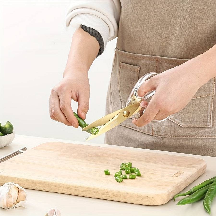 Ergonomic golden scissors cutting herbs and vegetables in the kitchen