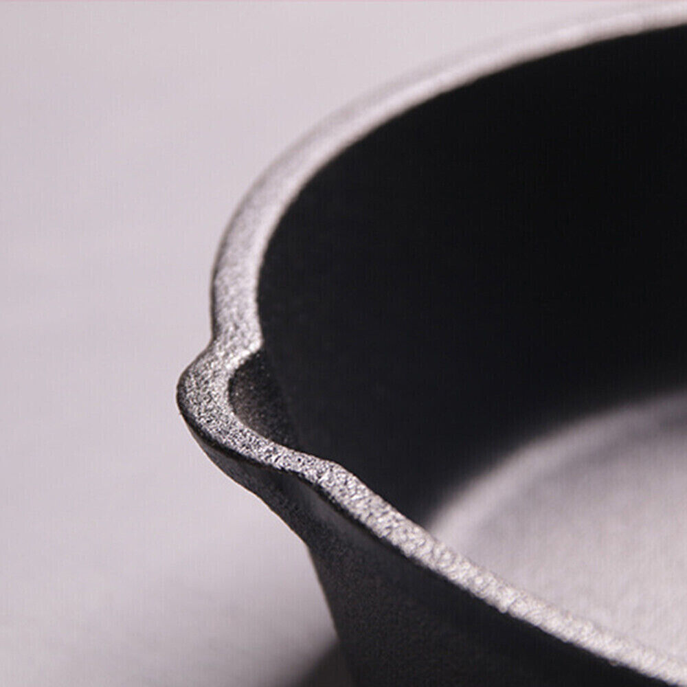 Close-up of a black cast iron skillet on a light gray background