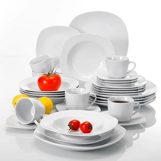 Set of white ceramic dinnerware with cups, saucers, and plates on a white background.