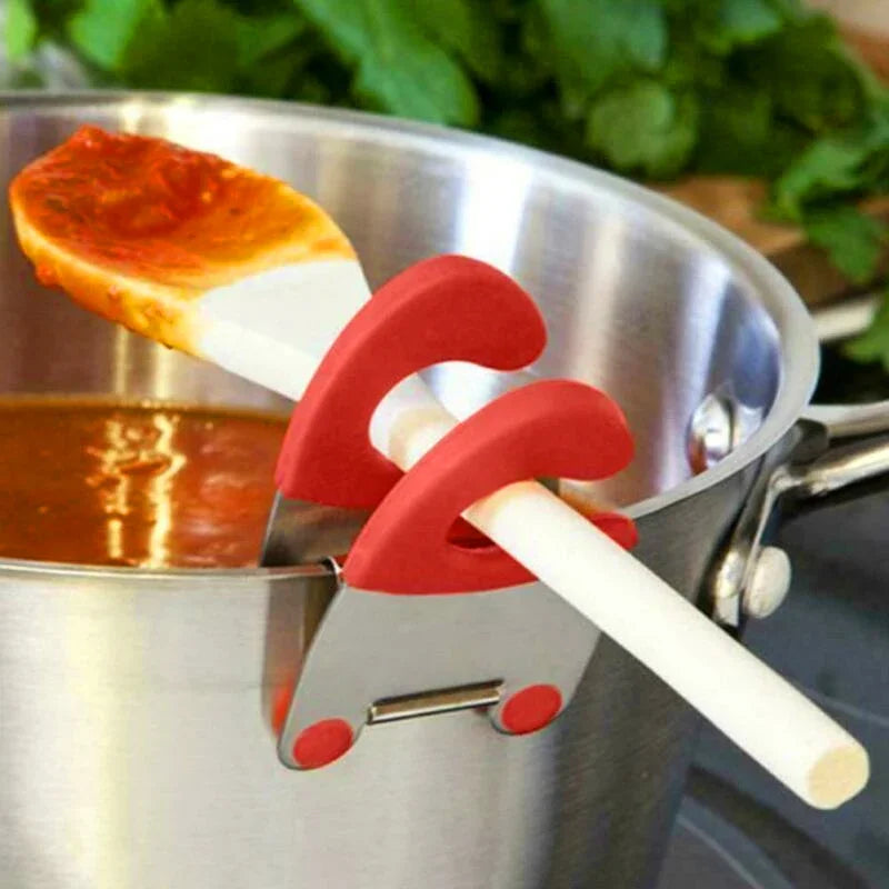 Silicone pot clip resting on the edge of a stainless steel pot.