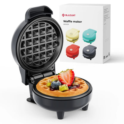 Waffle maker with a cooked waffle and fruit toppings, next to its packaging.