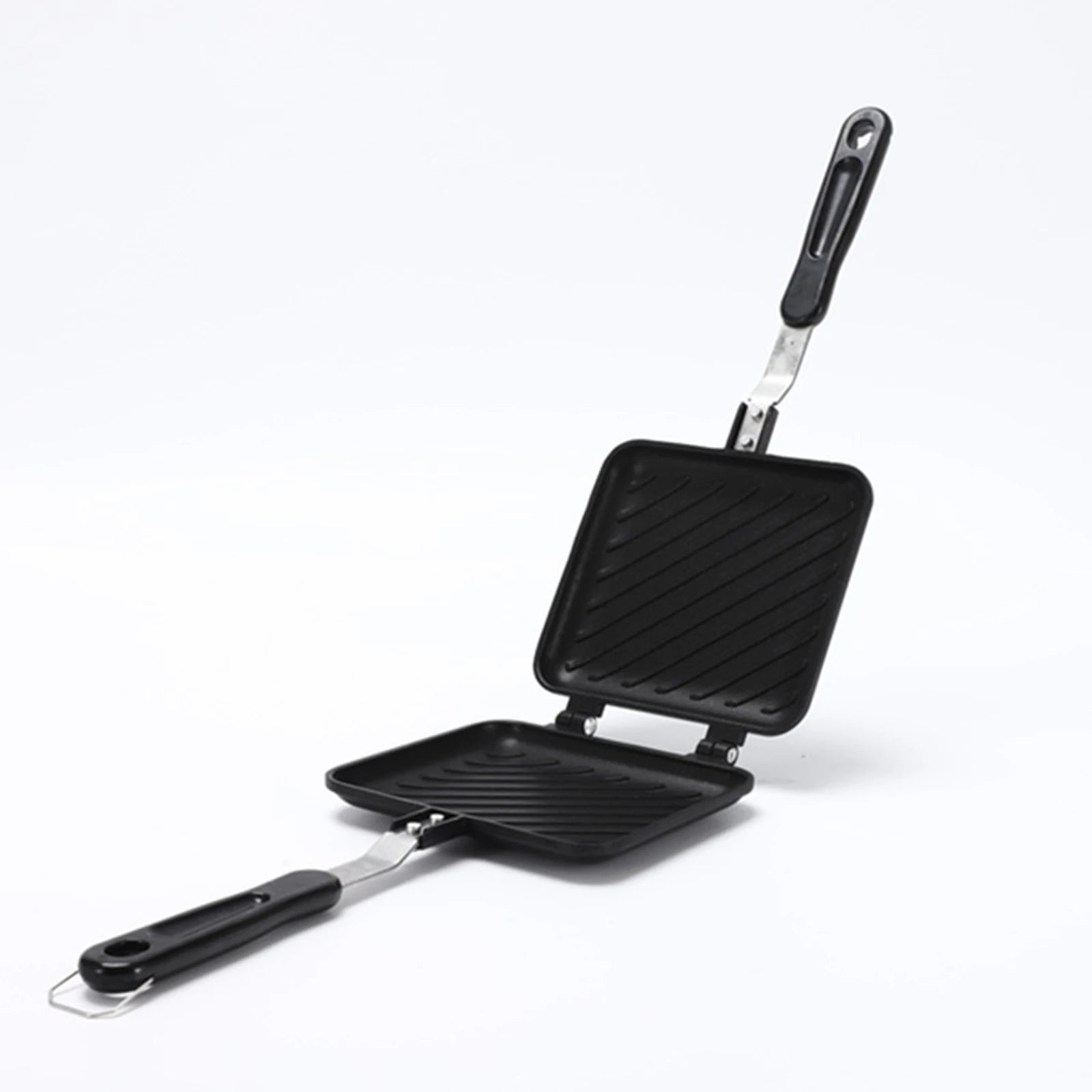 Black double-sided grill pan with two distinct cooking surfaces on a white background