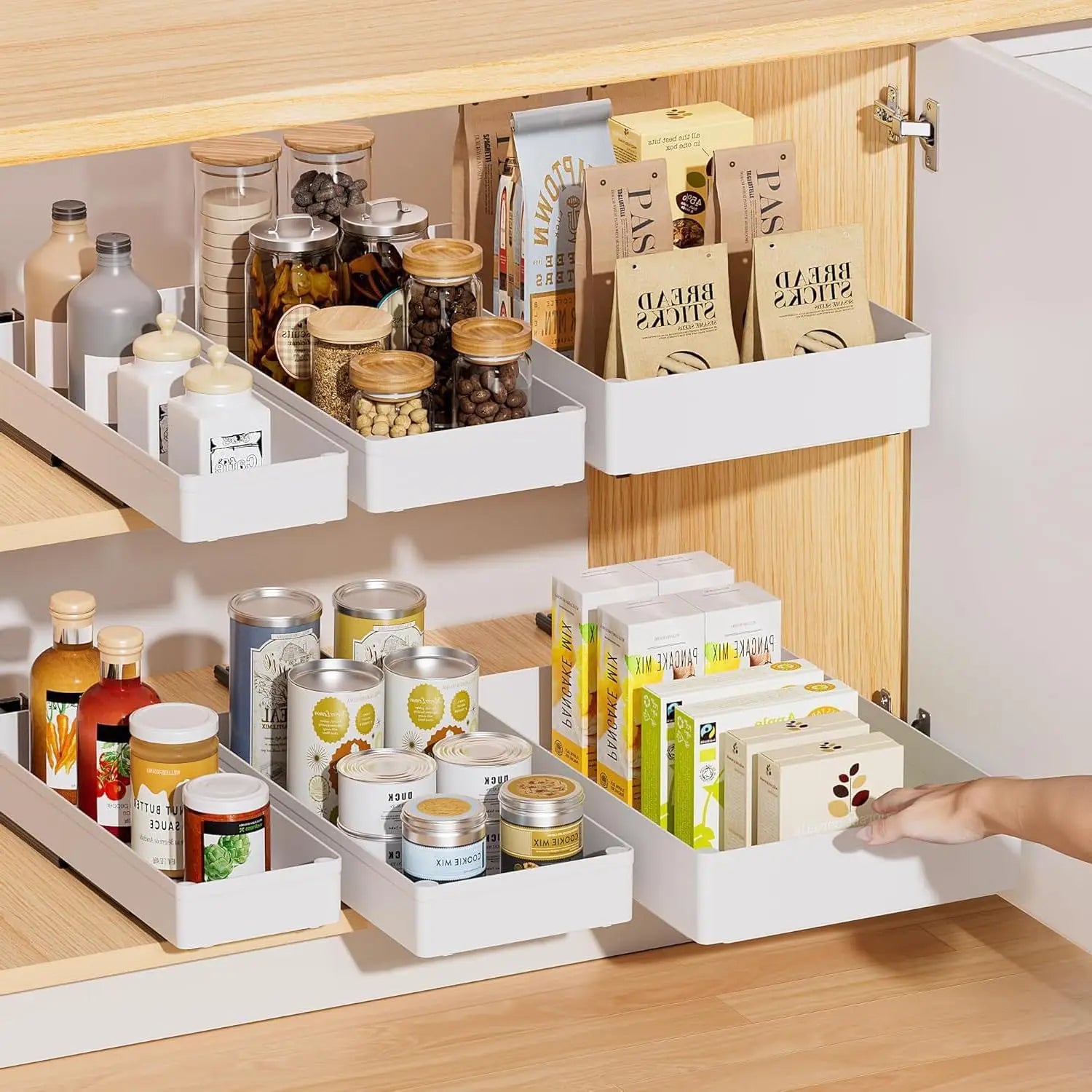Kitchen cabinet with organized shelves containing various food items and containers.