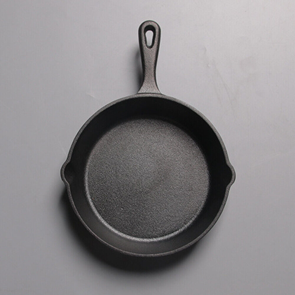 Black cast iron skillet on a gray background