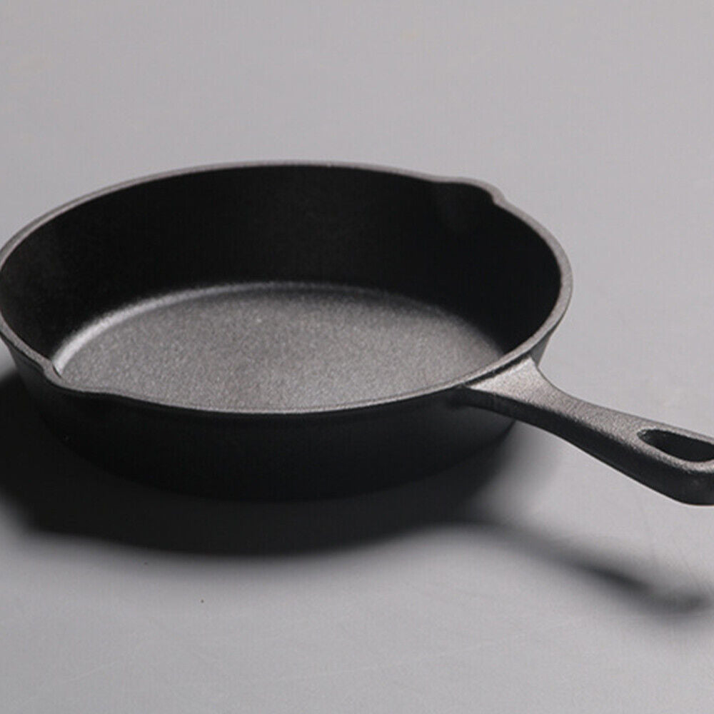 Black cast iron skillet on a gray background