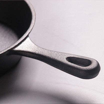 Close-up of a cast iron skillet on a light gray background